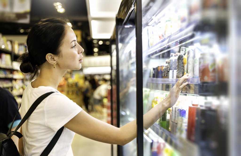 woman looking at product at grocery store