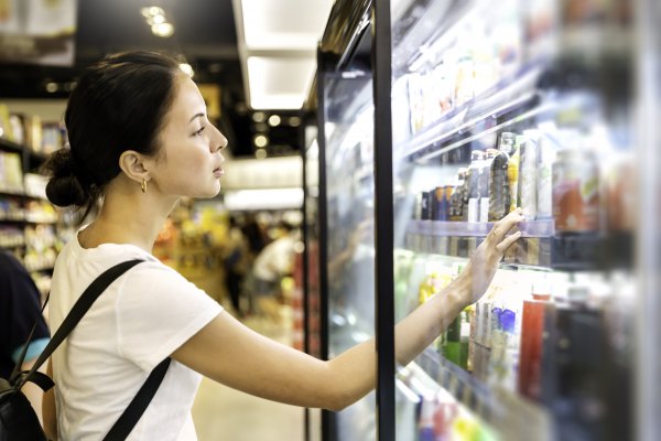 woman looking at product at grocery store